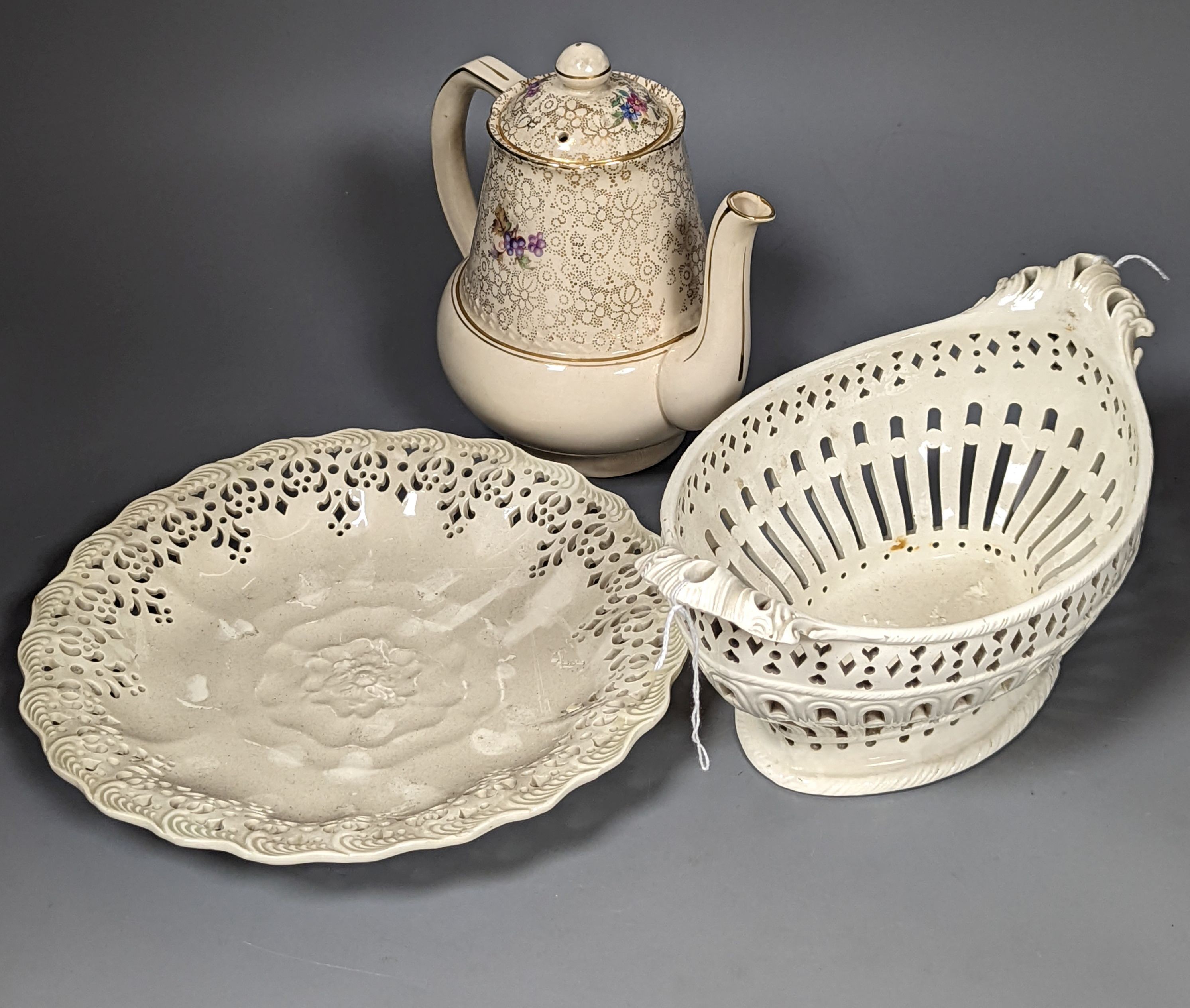 An English 18th century creamware chestnut dish and stand and a serpentine dish, A gilt decorated jug and basin and a teapot, jug and basin set, 30cms high